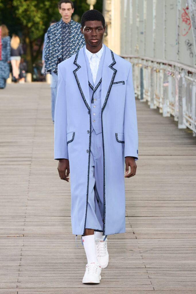 A relaxed blue cotton coat suit featuring a collared long-sleeve design with buttoned details.