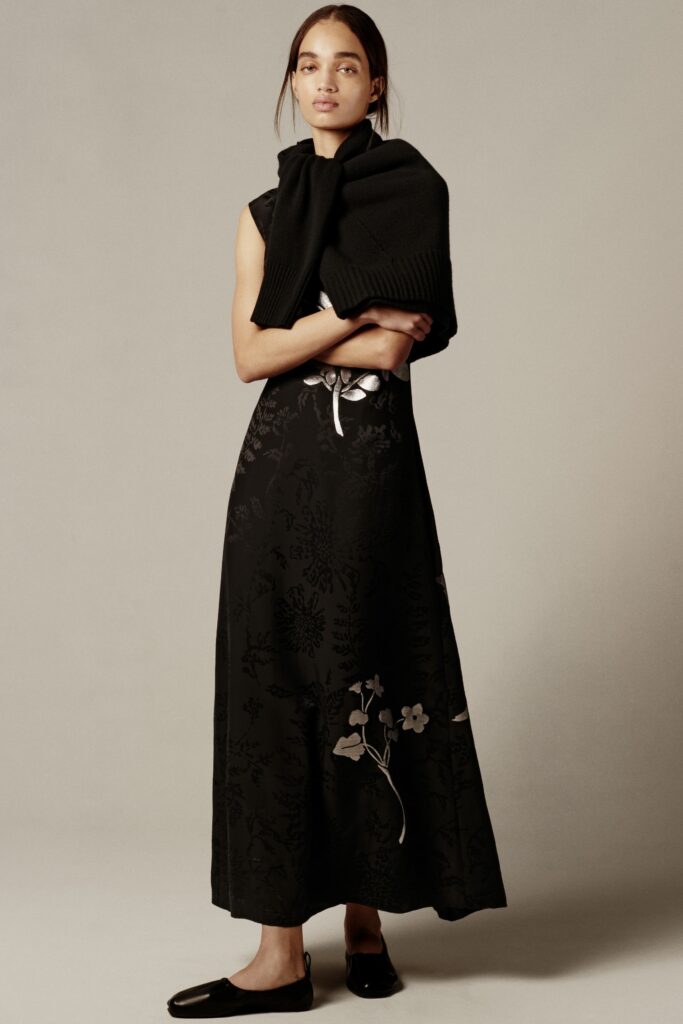 A relaxed black floral sleeveless dress with a V-neckline, perfect for casual occasions.