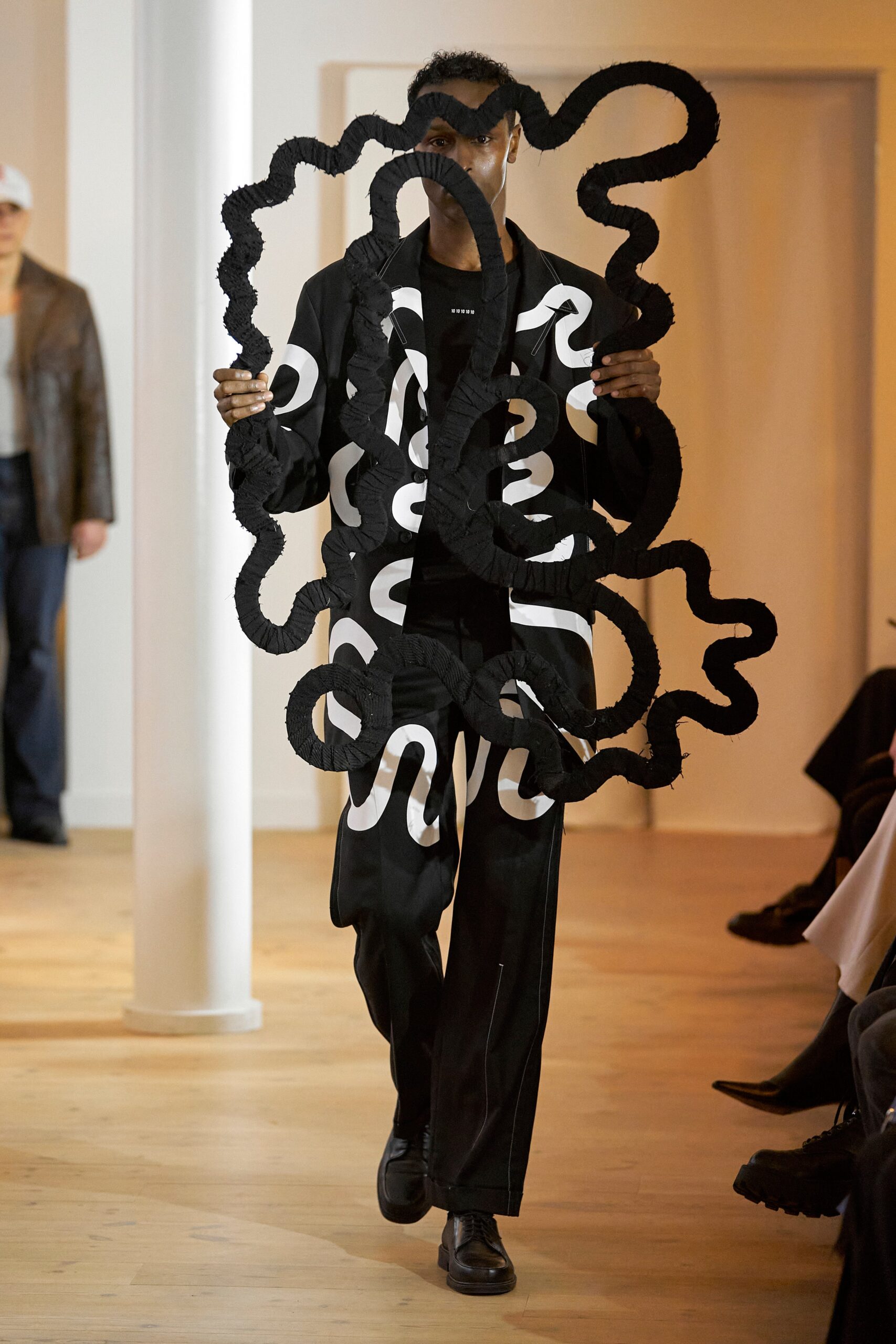 A relaxed-fit black and white printed jacket with long sleeves and matching pants.