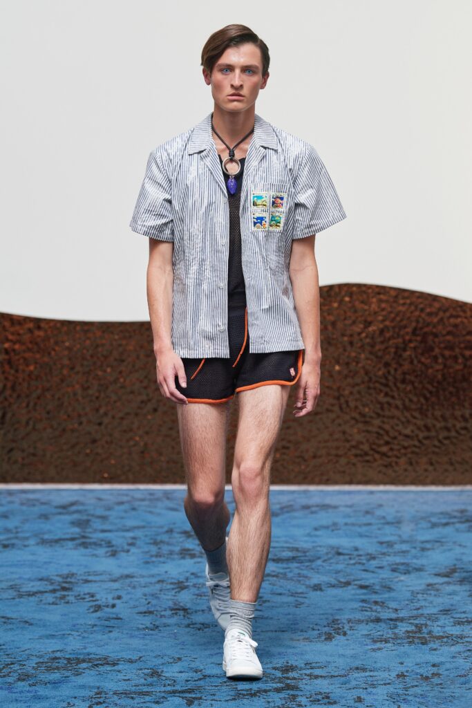 A fitted blue striped short-sleeve shirt paired with black shorts, perfect for a casual summer look.