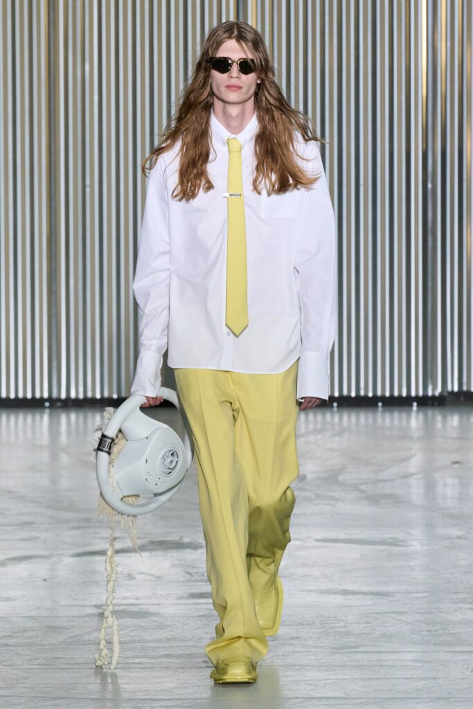 An oversized white long-sleeve shirt with a collar paired with straight-leg yellow pants.