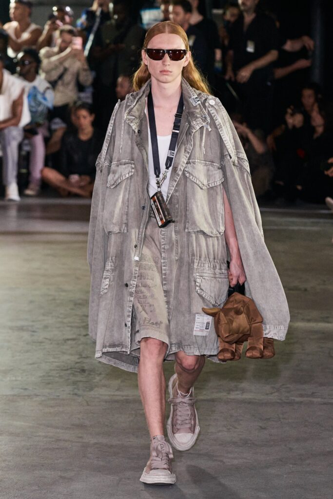 A relaxed gray denim dress with a long-sleeve collared jacket layered over it.