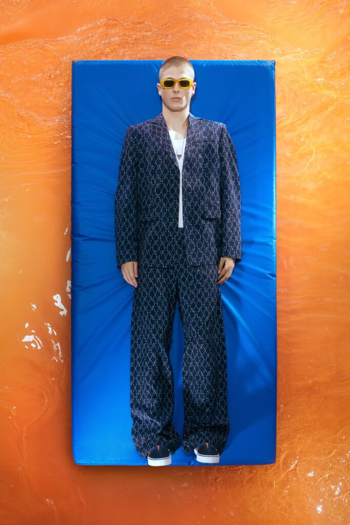 A relaxed blue suit with a long-sleeve collared shirt featuring a printed design.