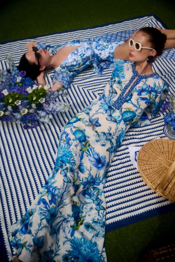 A fitted blue floral dress with long sleeves and a V-neckline featuring a flared silhouette.