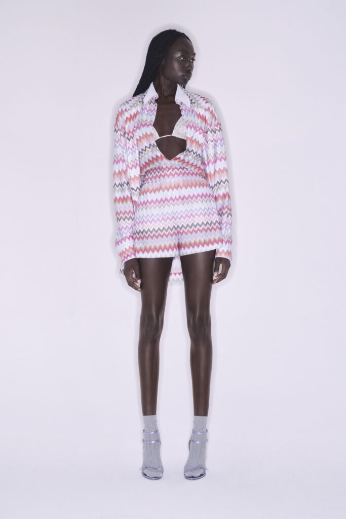 A fitted pink and white striped dress with a collared shirt and asymmetric design.