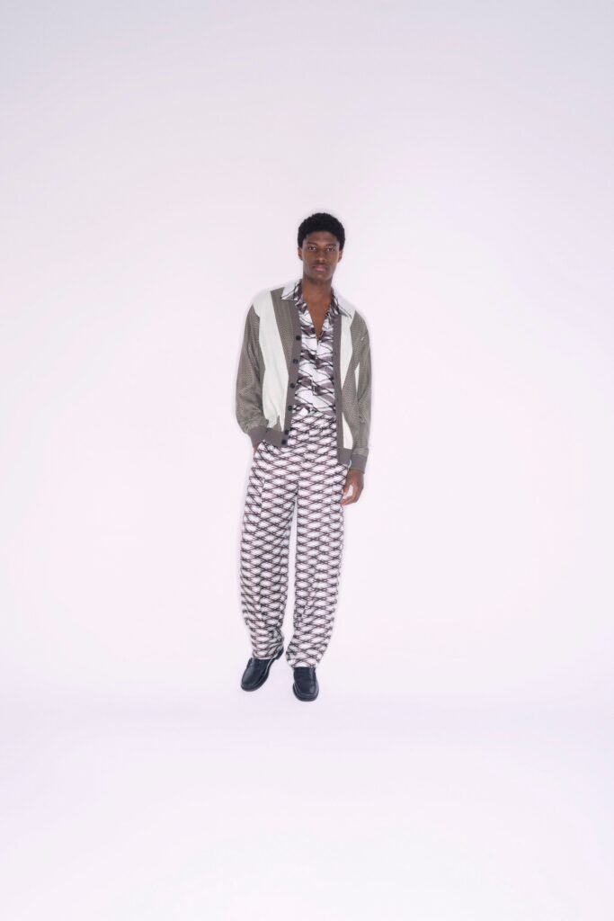 A relaxed gray cotton jacket paired with printed pants featuring a collared neckline.