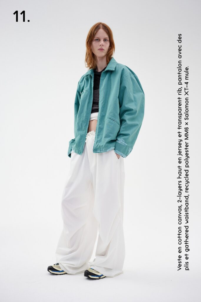 A relaxed blue cotton jacket paired with white pants, featuring an oversized silhouette.