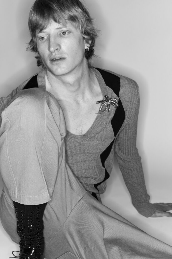 A fitted gray sweater with a V-neckline and asymmetric design paired with matching pants.
