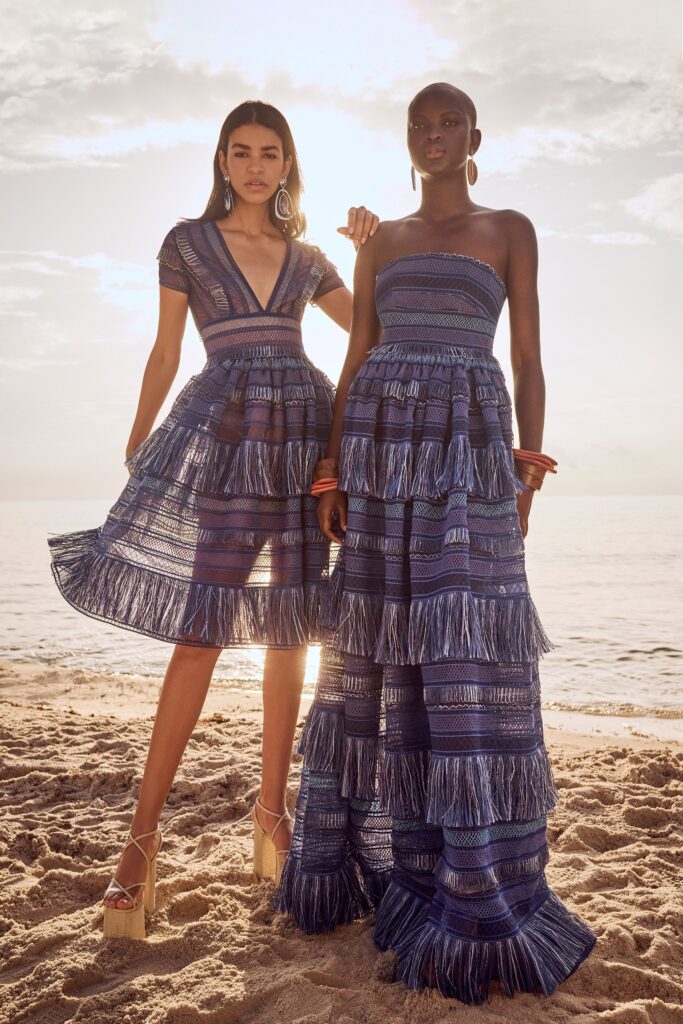 A relaxed blue cotton sleeveless dress with a V-neckline and tiered design.