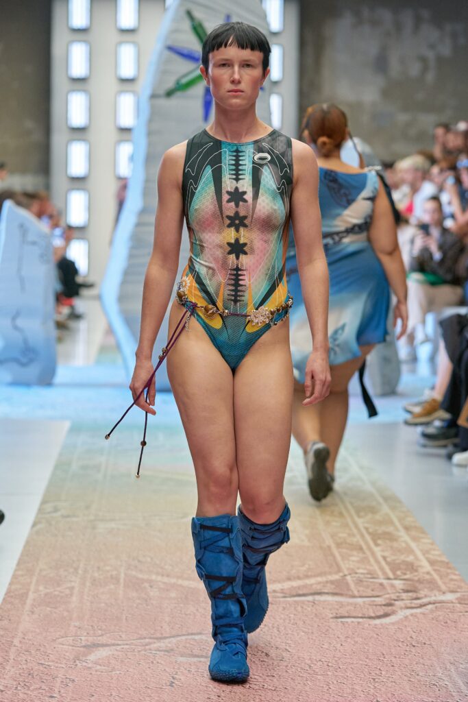 A fitted multicolor swimsuit with a high neckline and printed design details.