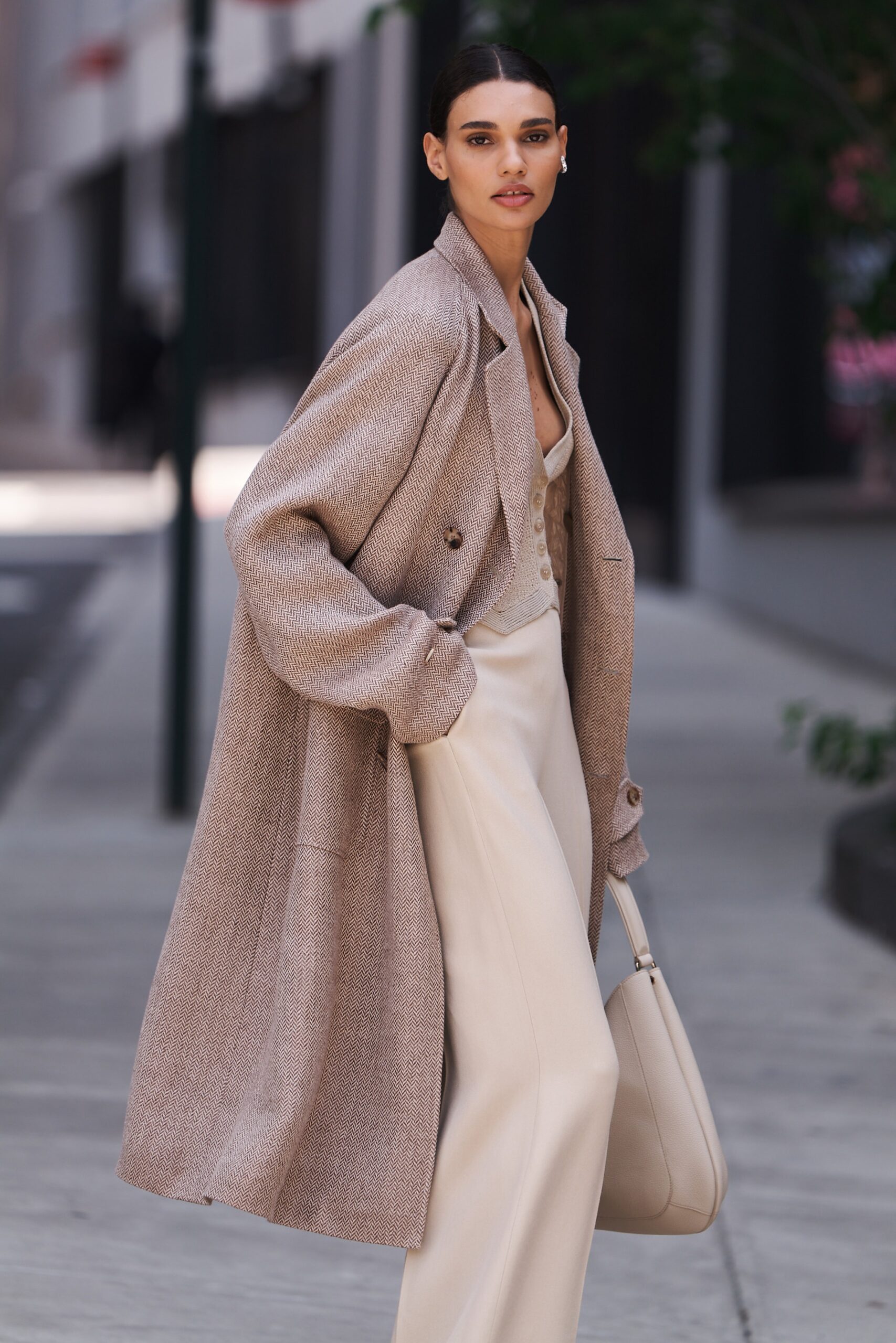 A relaxed beige wool coat paired with wide-leg pants for a chic look.