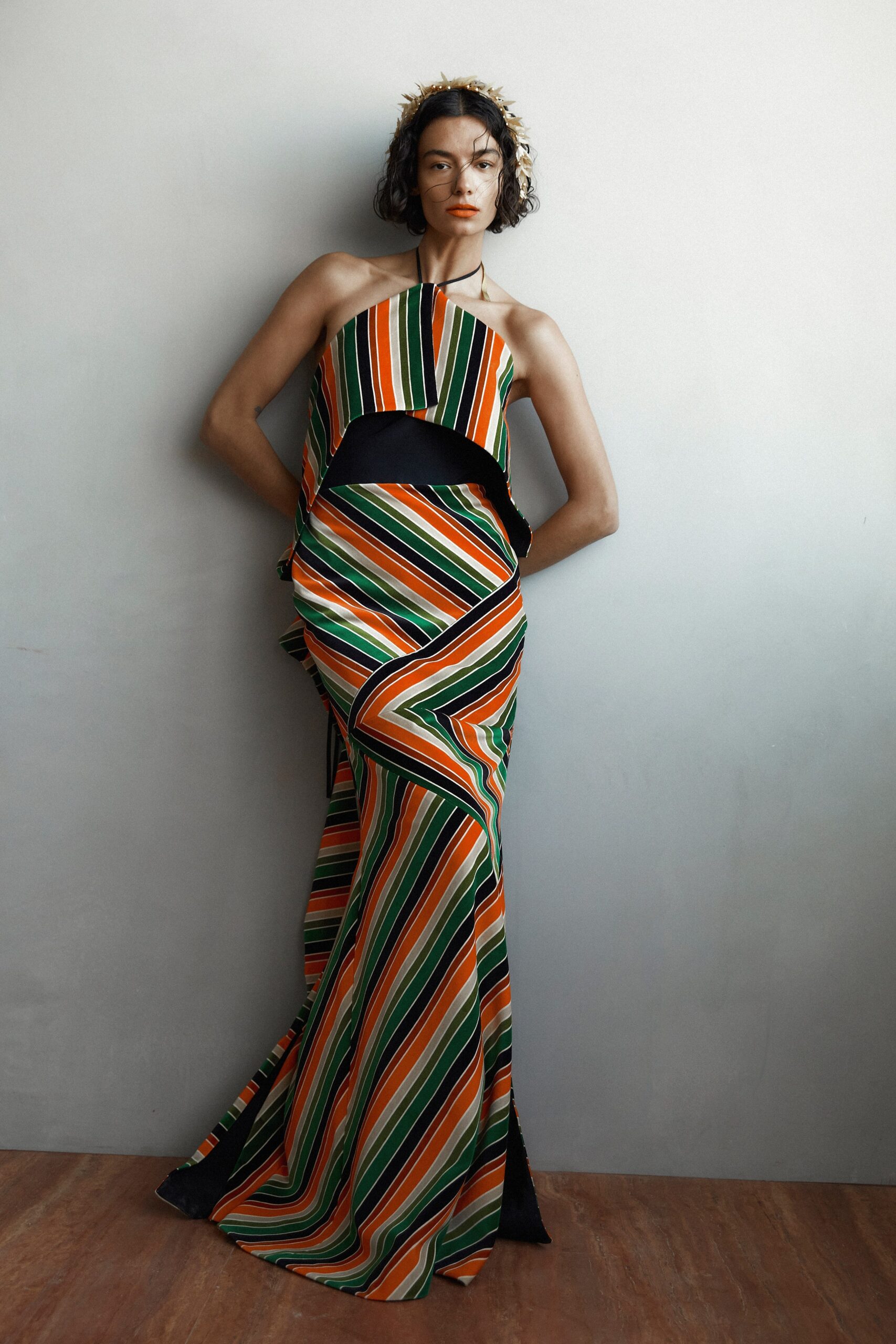 A fitted multicolor silk halter dress with an asymmetric design.