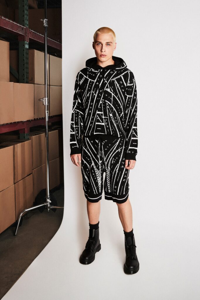 A relaxed black and white printed hoodie paired with matching shorts for a casual look.
