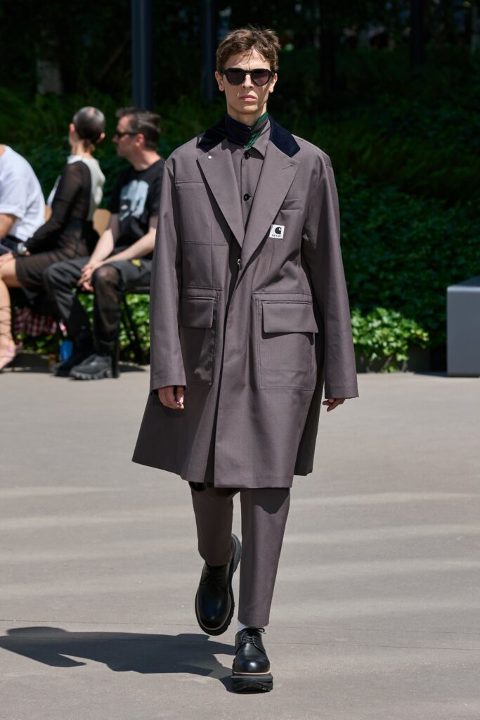 A relaxed brown cotton coat with a collared neckline and buttoned details.
