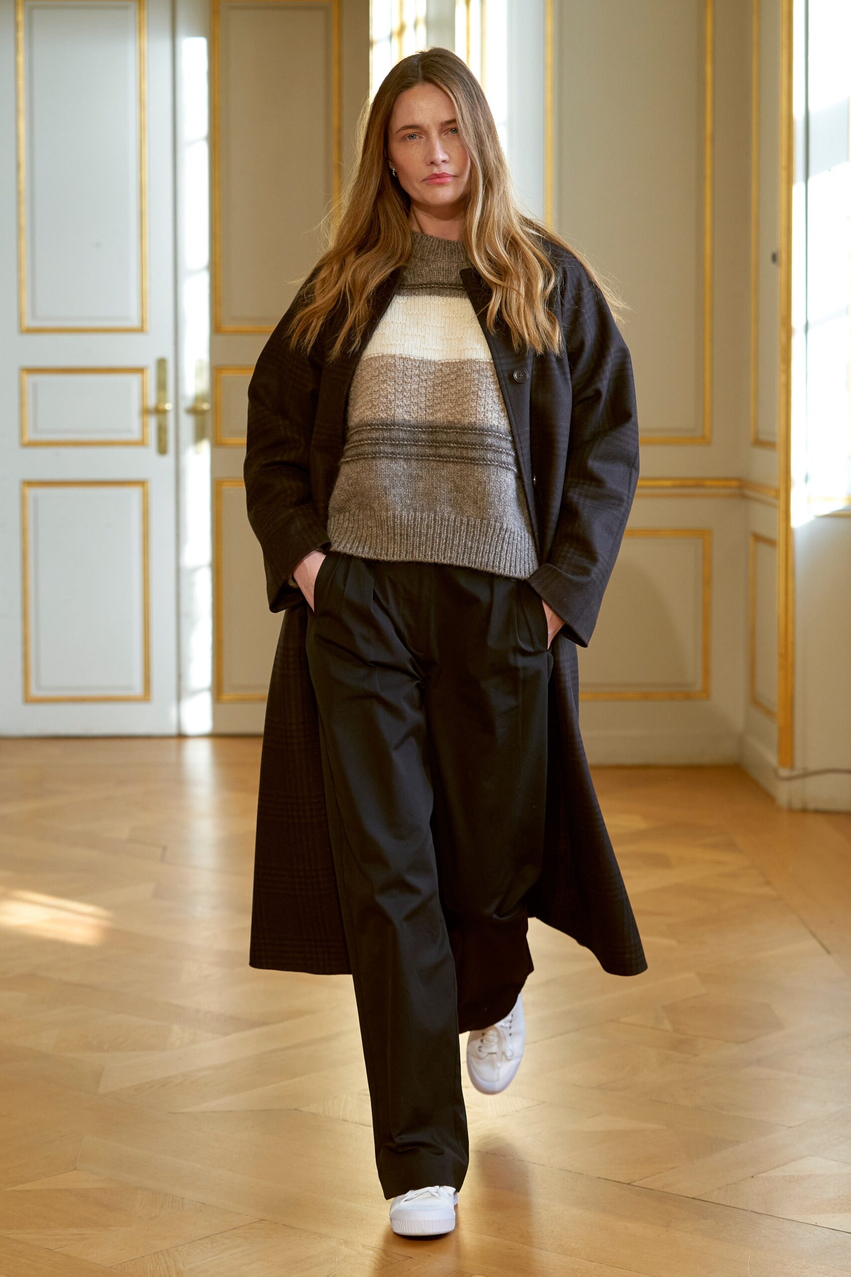 black coat gray striped sweater black pants