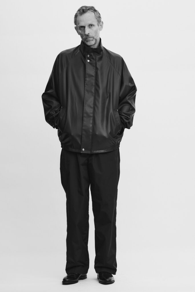 An oversized black leather jacket paired with matching black pants for a sleek look.