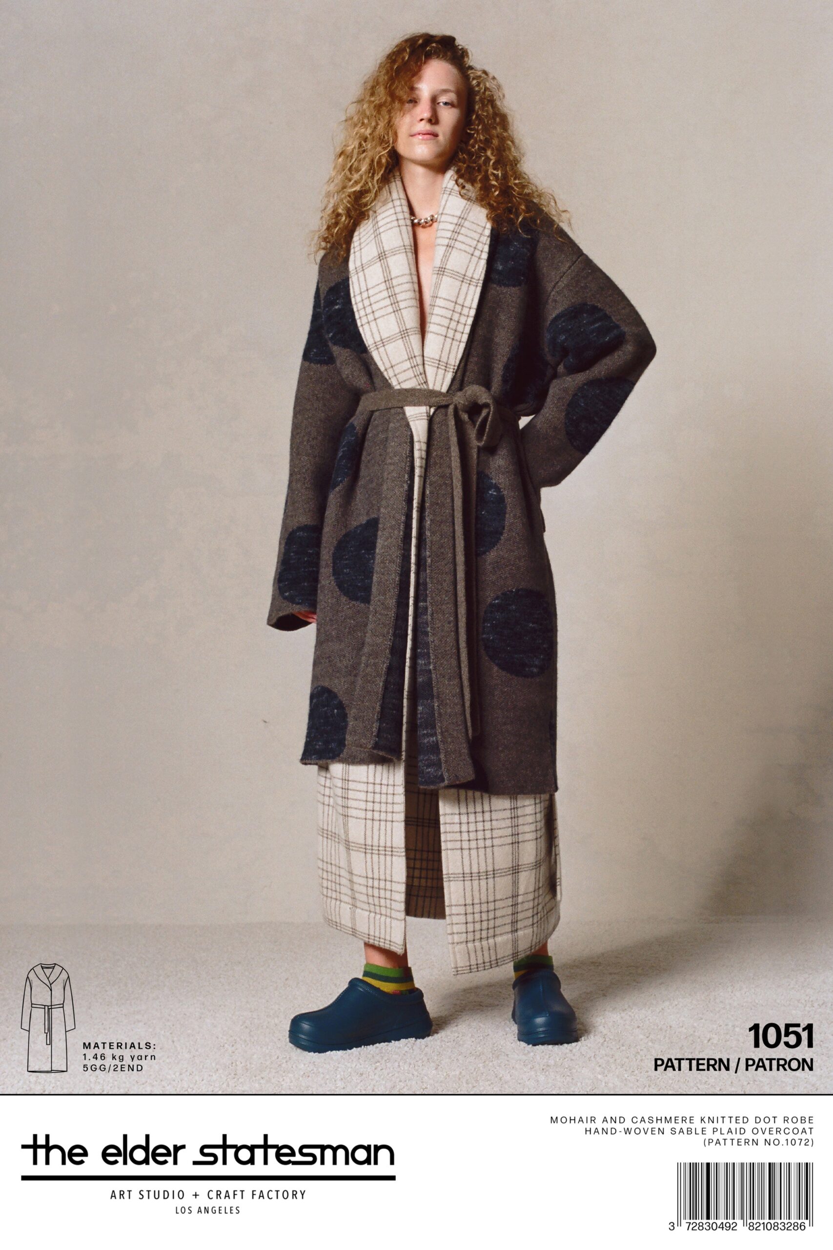A relaxed brown wool coat with long sleeves and a collared design, paired with printed pants.