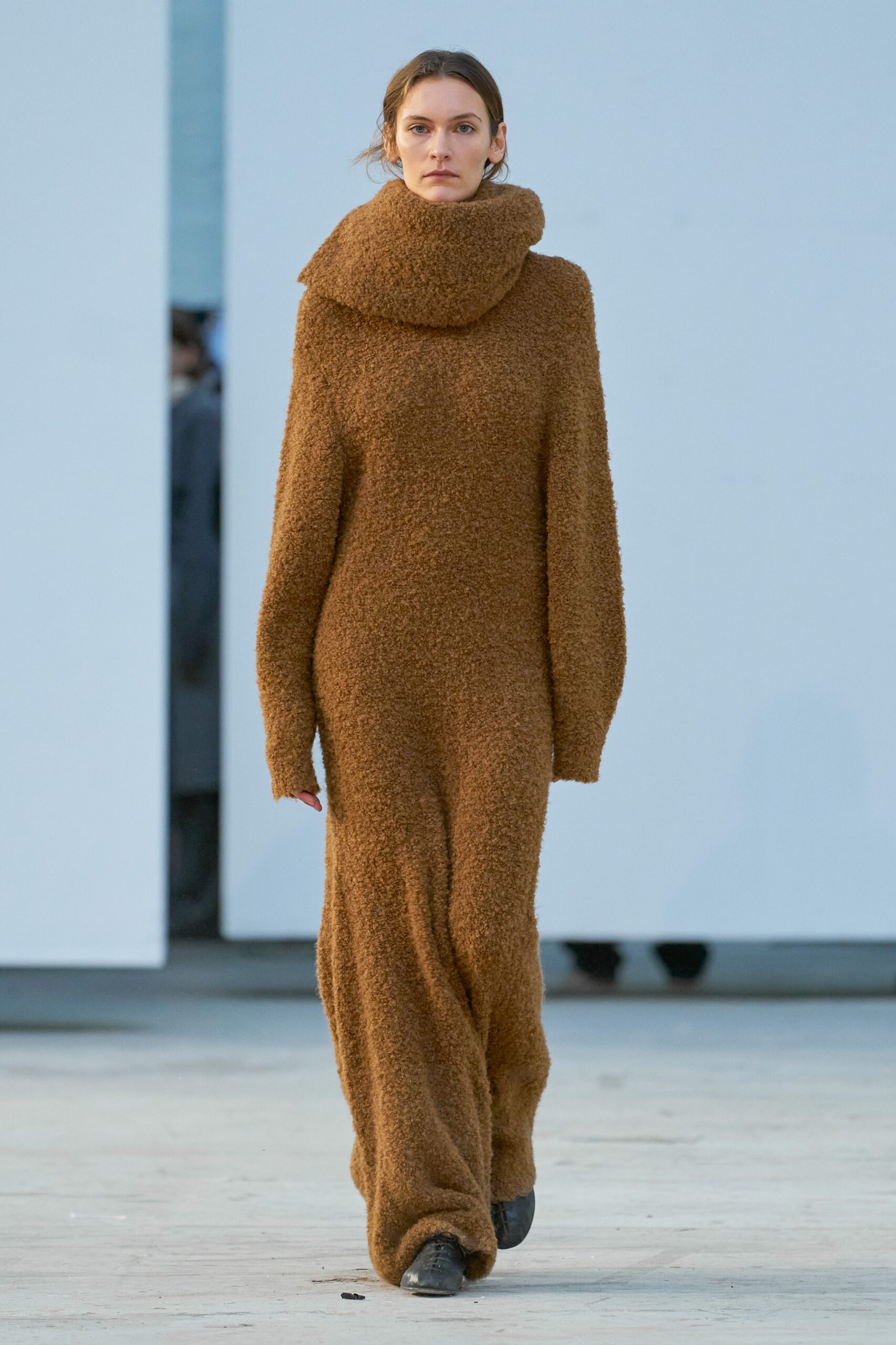 A relaxed brown wool dress with long sleeves and a high-neck design.