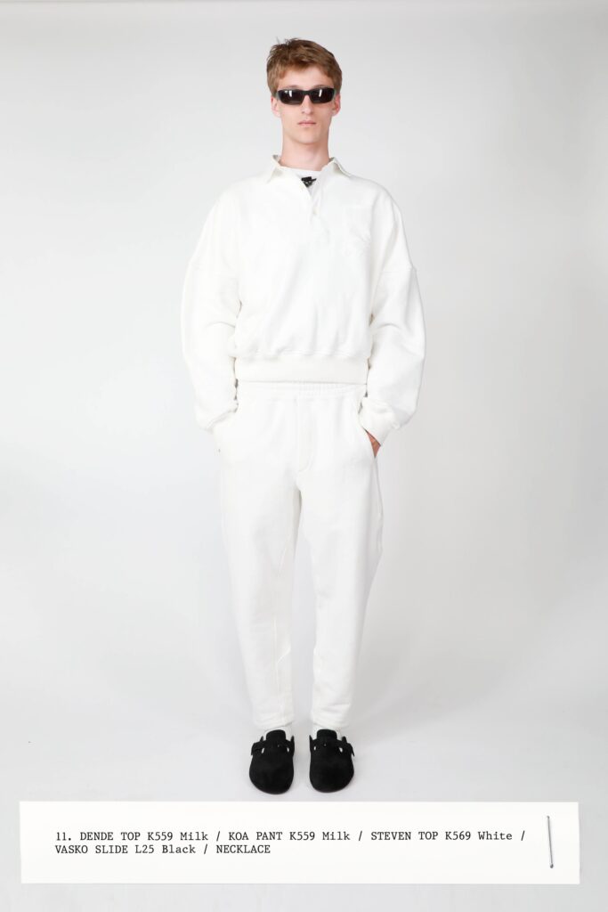 A relaxed white sweater with a zippered collar paired with matching pants.