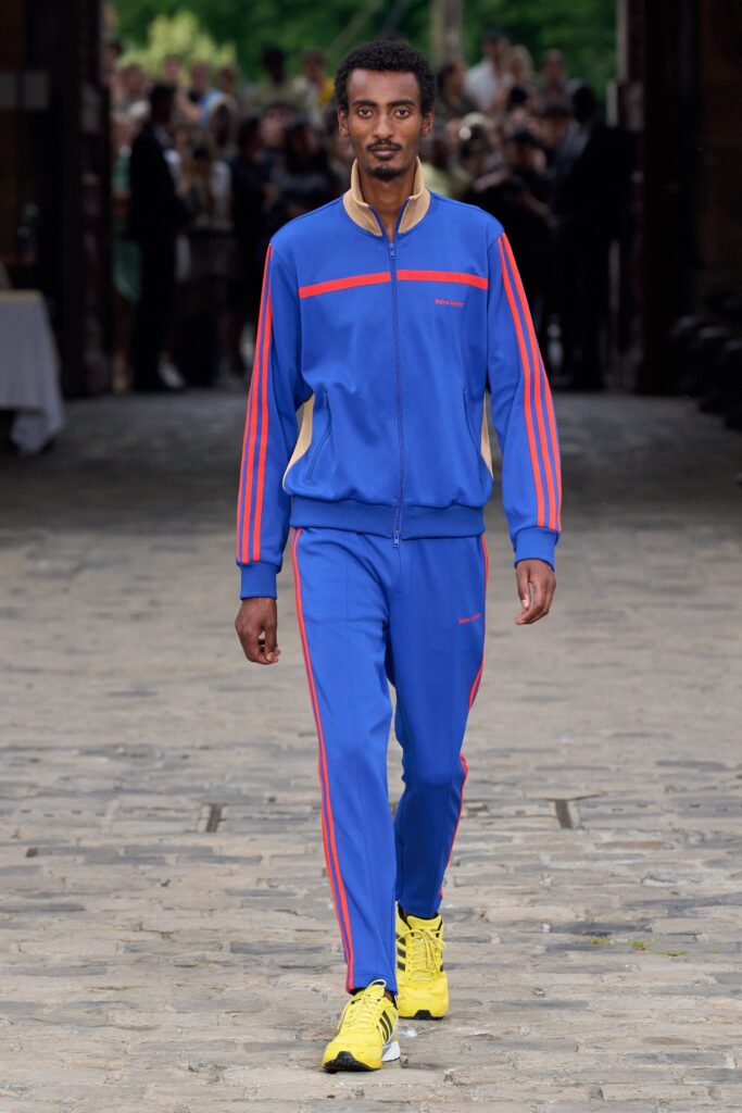 A relaxed blue jacket with long sleeves and striped details paired with matching pants.