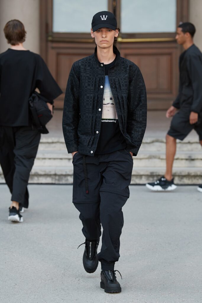 A relaxed black jacket with long sleeves and a collared design paired with matching pants.