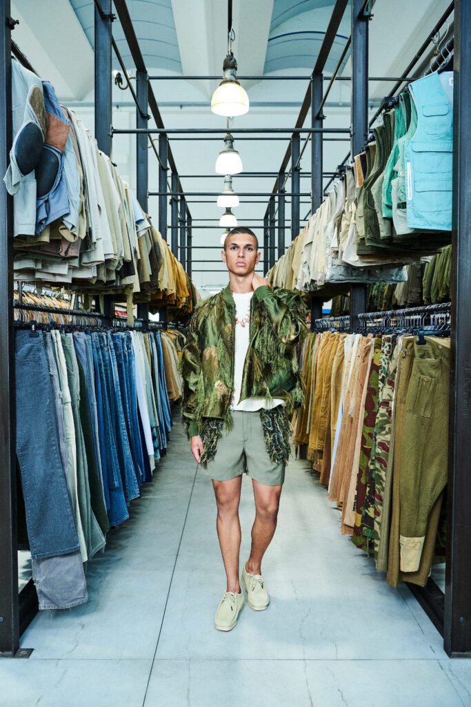 A relaxed green cotton jacket with fringed details paired with matching shorts.