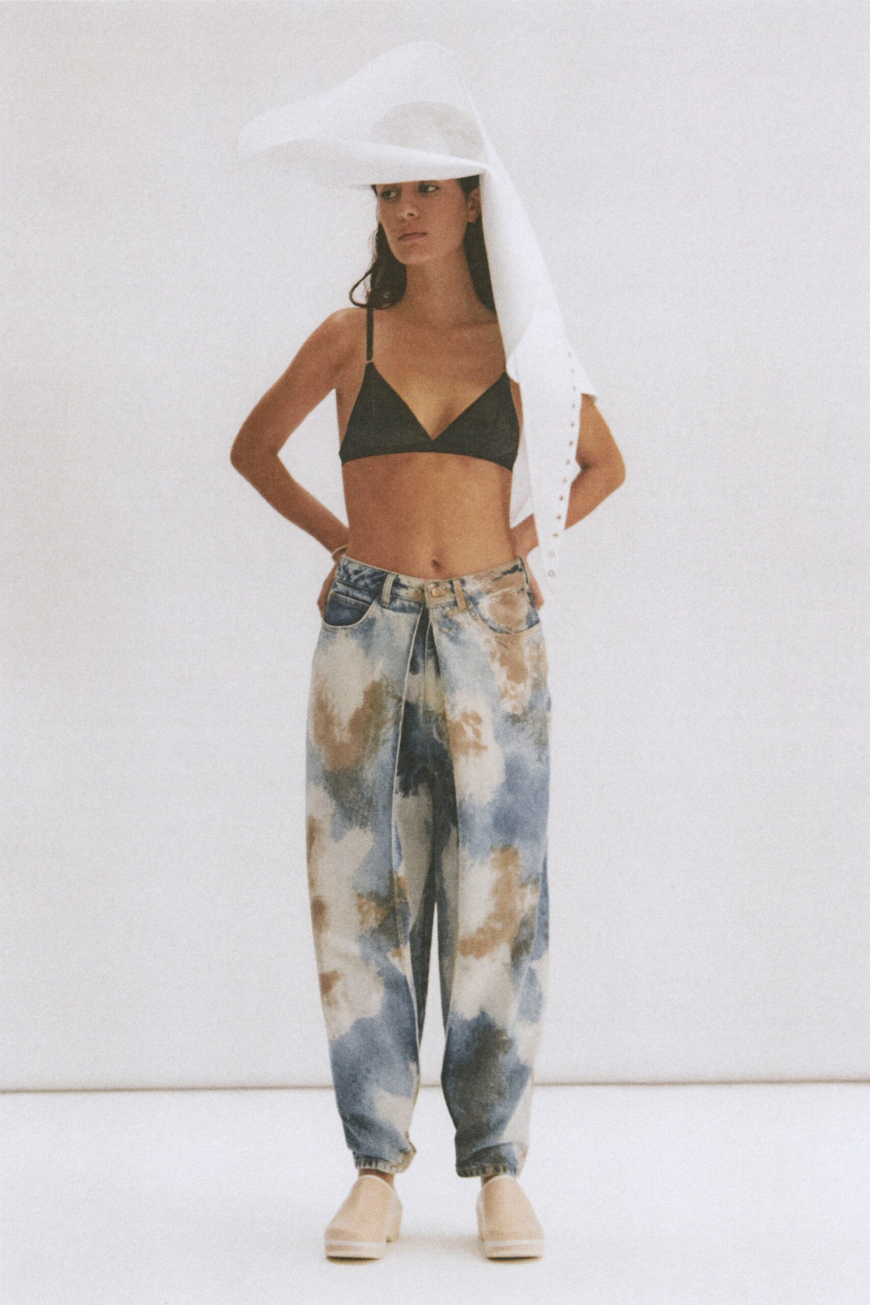 black bra and relaxed denim pants