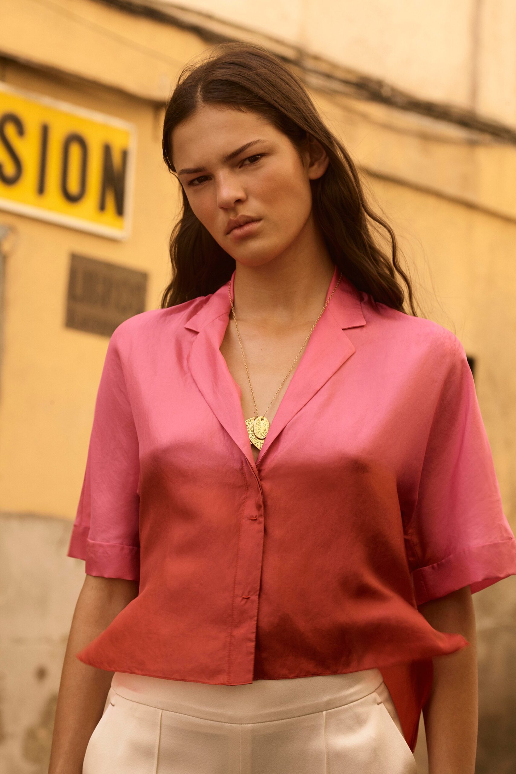 pink silk shirt with tailored pants