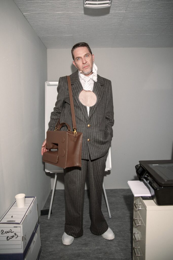 A tailored gray striped suit with long sleeves and a collared design.