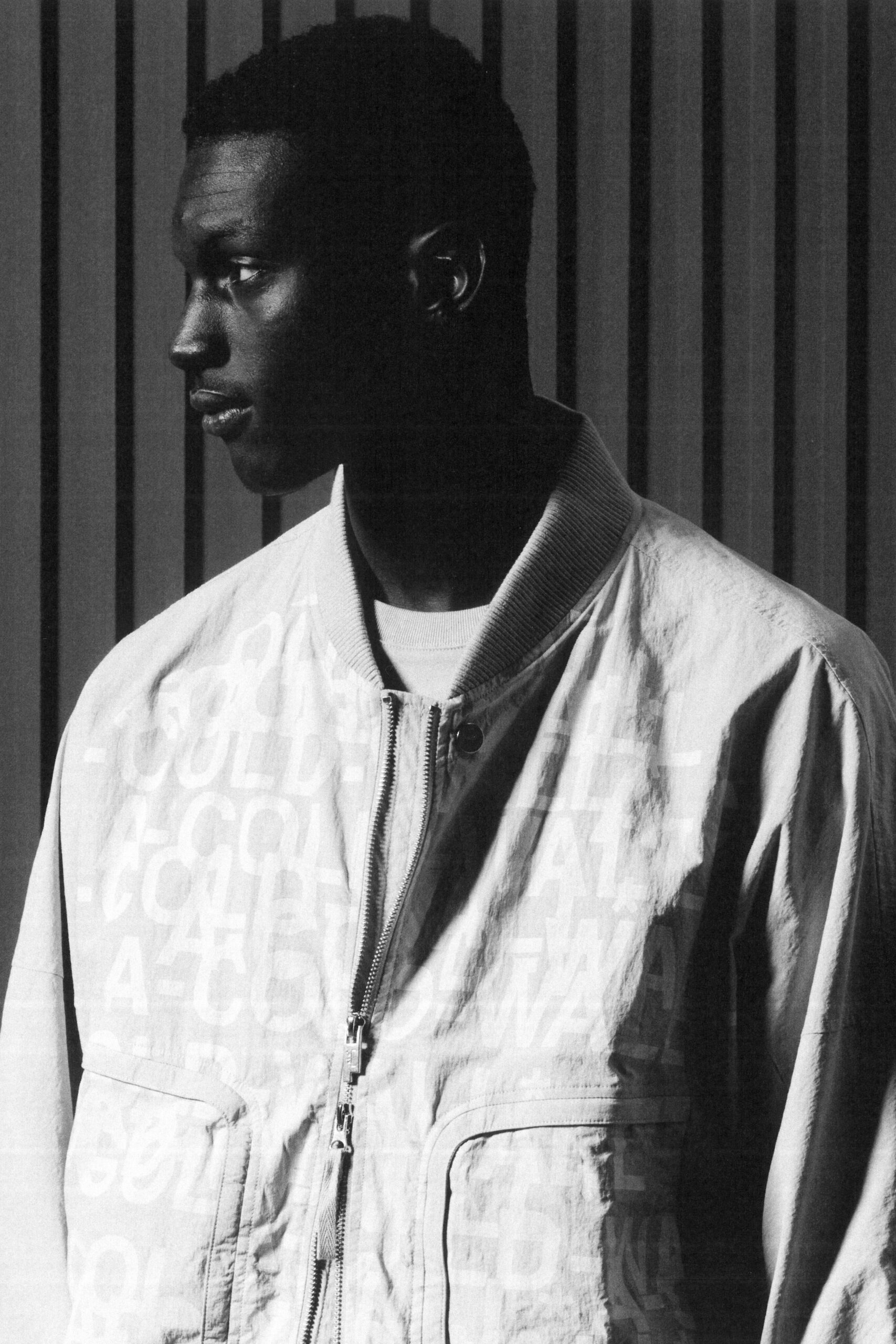 A relaxed white cotton jacket with long sleeves and a zippered front.