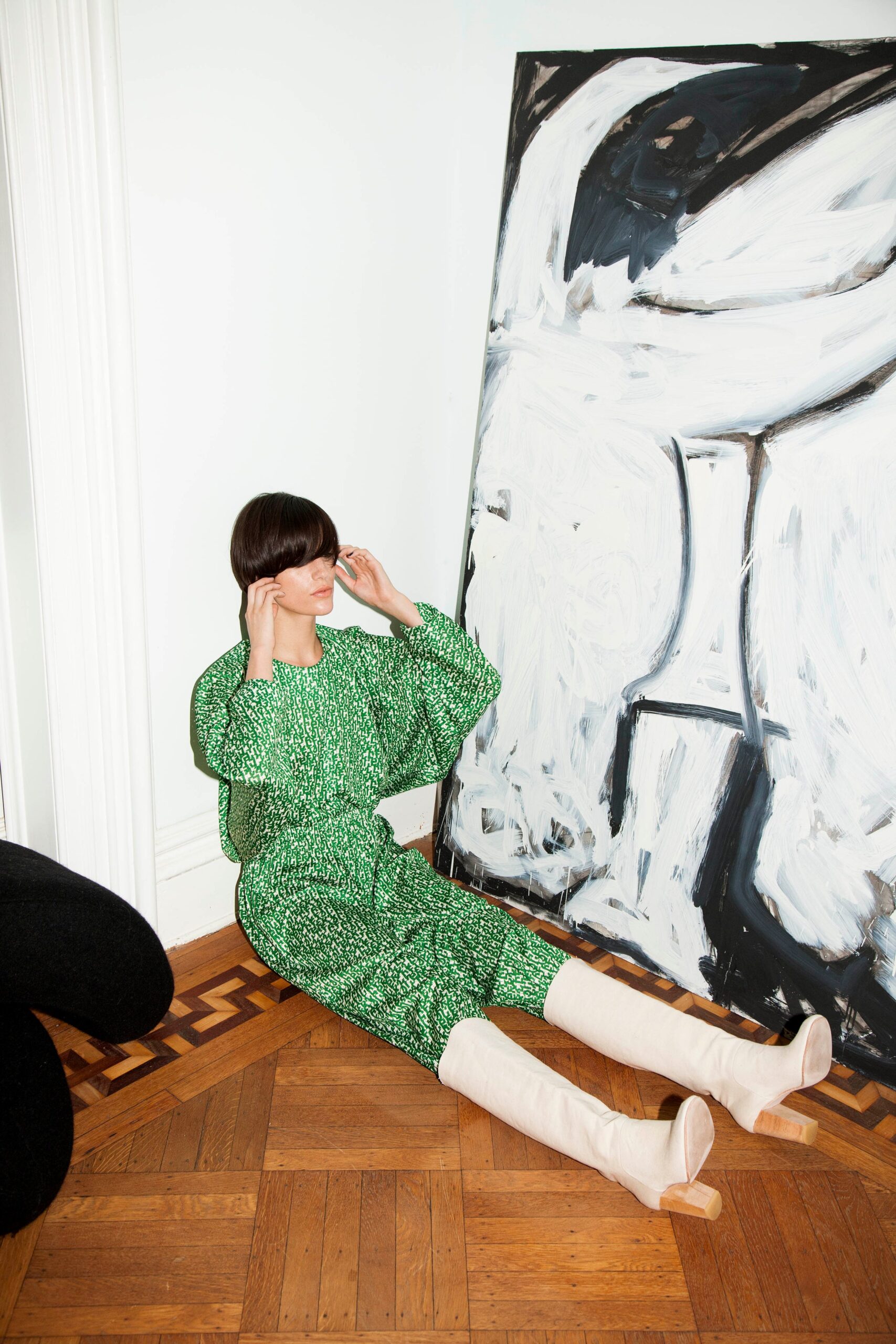 A relaxed green printed dress with long sleeves and a collared neckline.