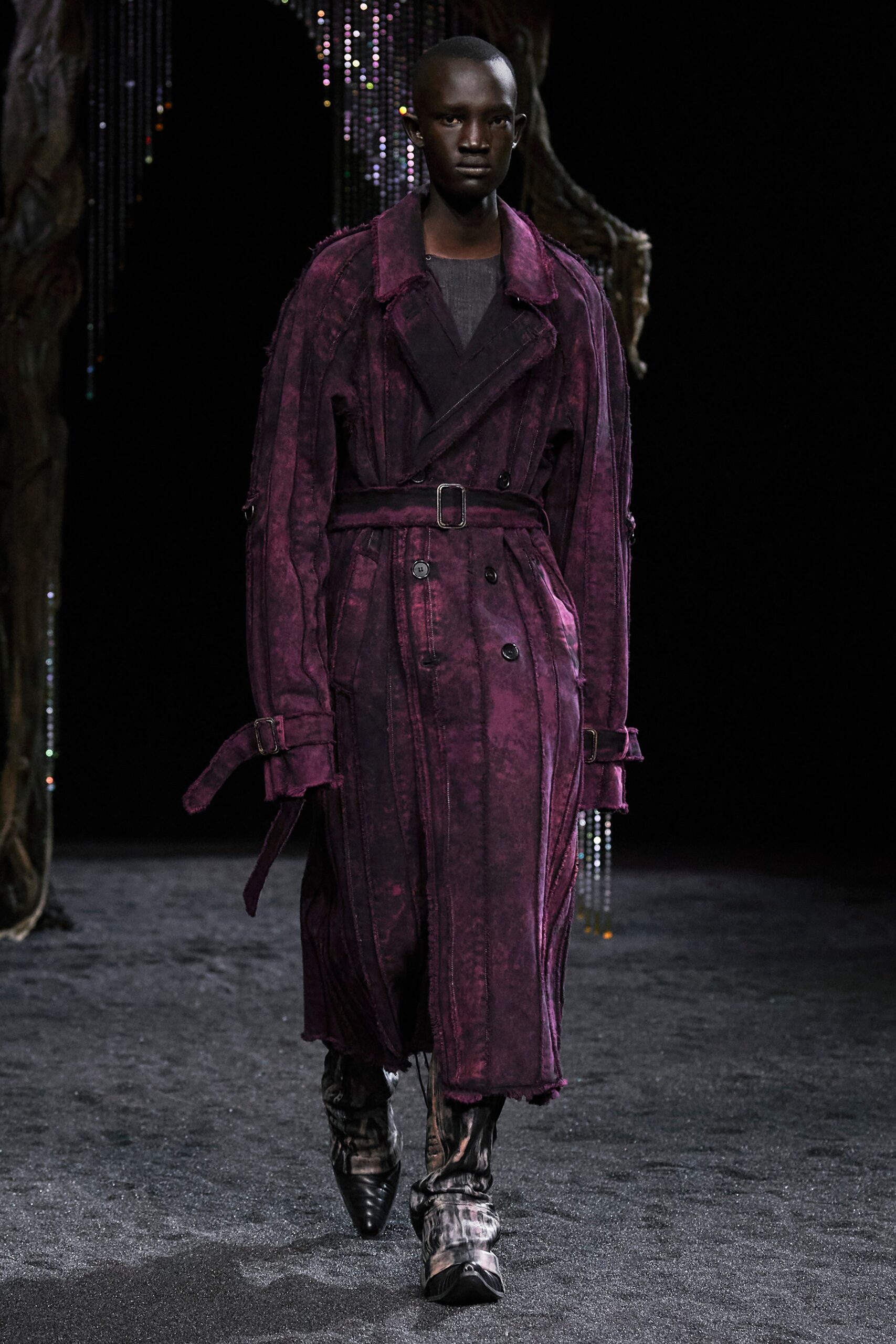 An oversized purple coat with long sleeves, a collared neckline, and buttoned details.