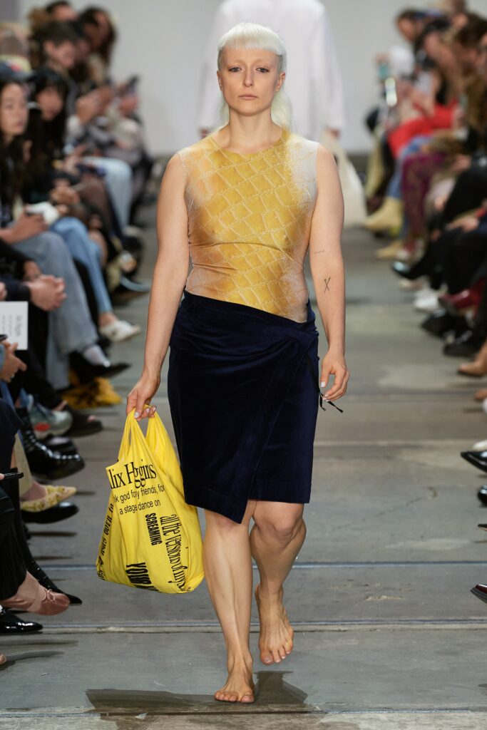 A fitted sleeveless dress featuring a layered asymmetric design in yellow and blue.