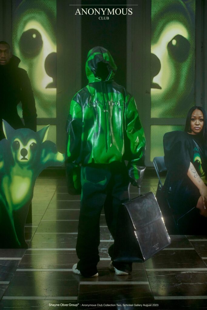 A relaxed fit green leather hooded jacket paired with matching pants featuring a zippered detail.