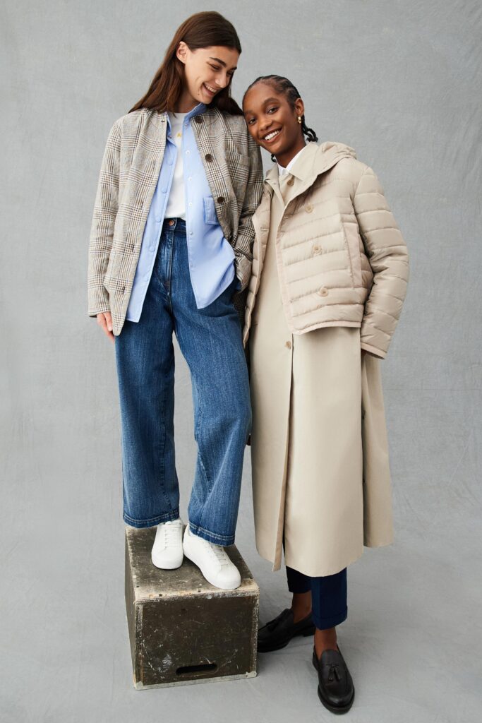 A relaxed-fit beige coat layered over a gray jacket with long sleeves and a collared design.