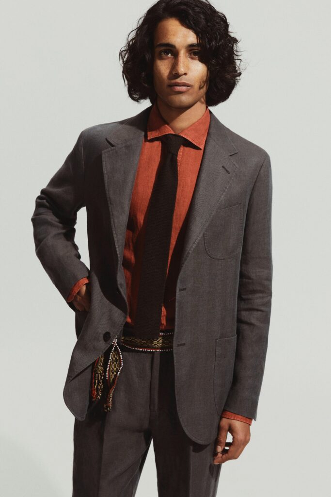 A tailored gray suit paired with a long-sleeve red collared shirt.