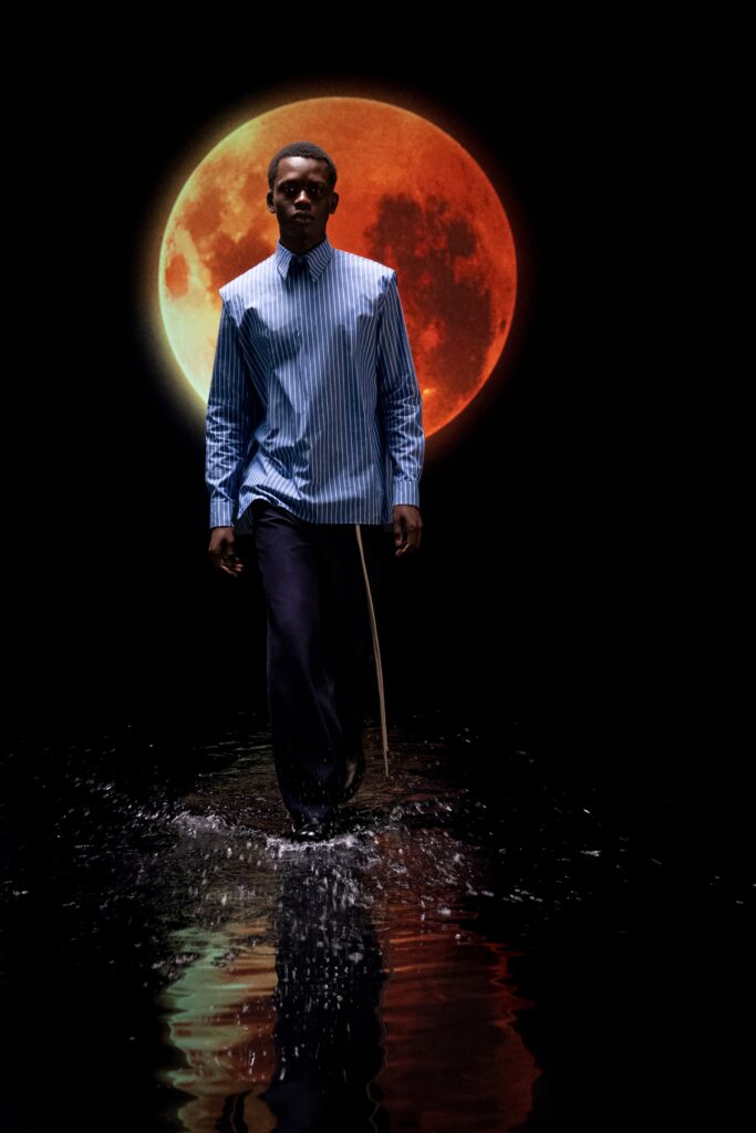 blue striped shirt and black pants