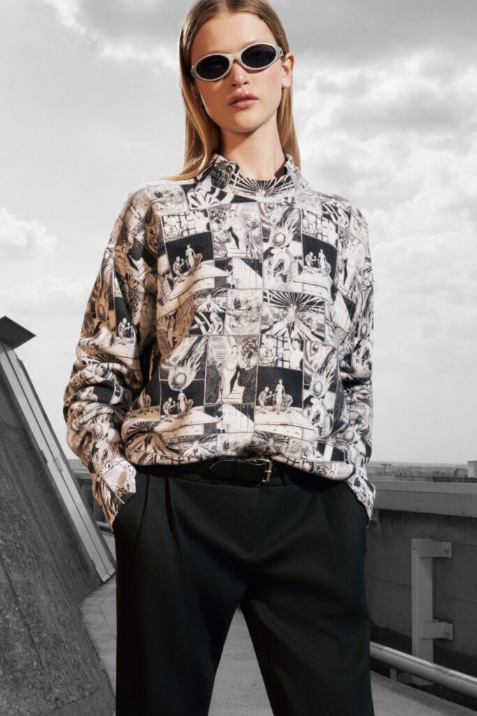 A relaxed black and white printed shirt paired with black pants, featuring a collared design.