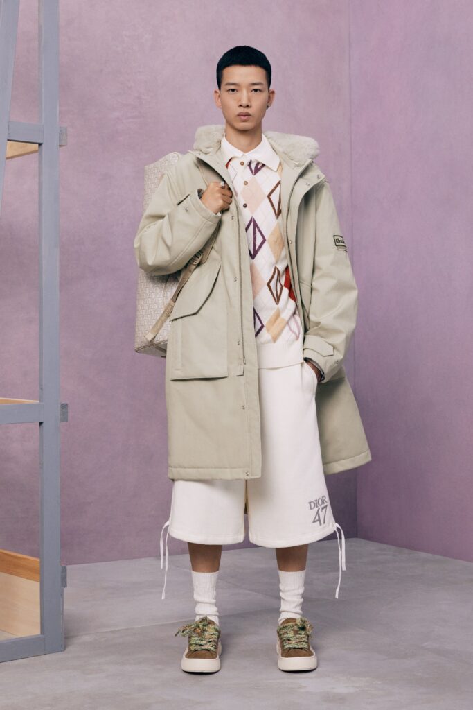 An oversized beige coat paired with white shorts, creating a modern and relaxed look.