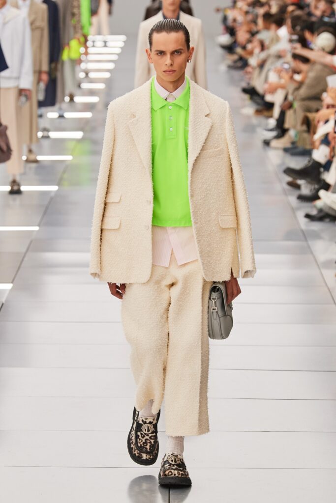 A relaxed white jacket with long sleeves and collared neckline paired with matching pants.