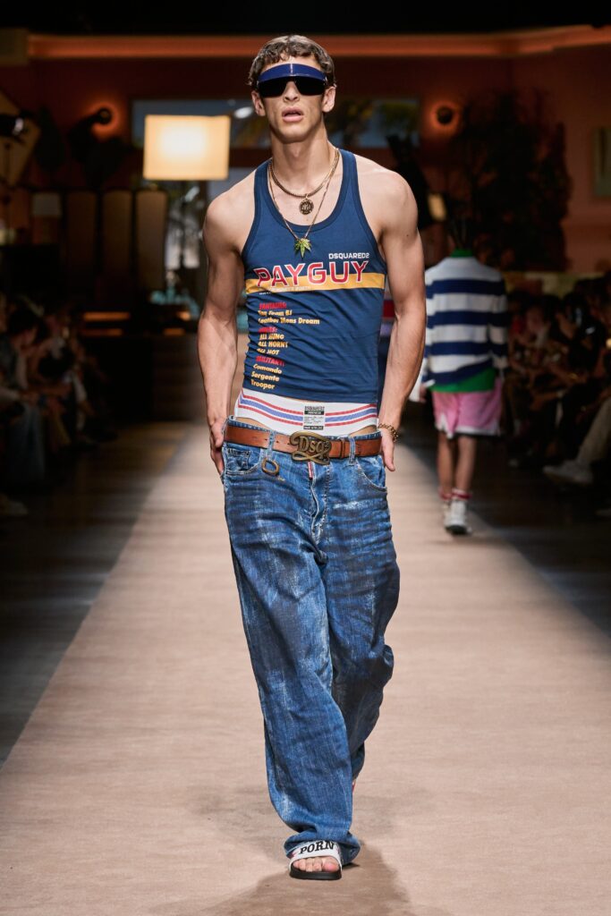 A relaxed blue printed tank-top paired with wide-leg denim pants for a casual look.