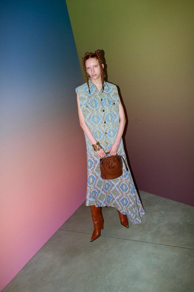 A relaxed blue cotton sleeveless dress with a collared neckline and printed design.