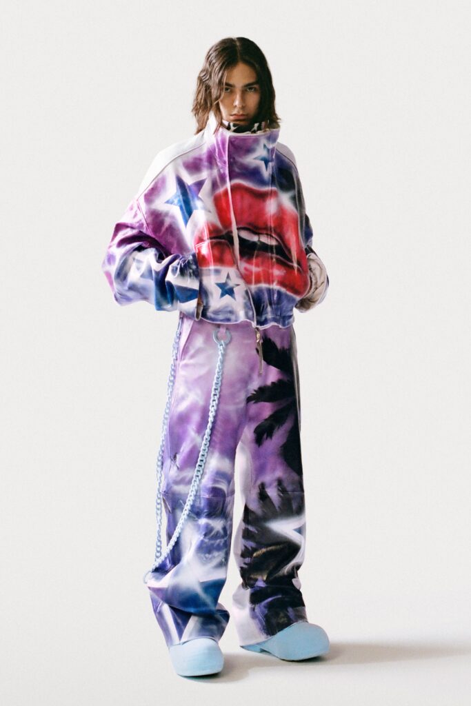 An oversized jacket and pants set featuring a vibrant print with red and blue accents.