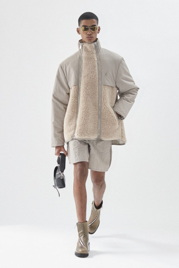 A relaxed-fit beige faux-fur jacket paired with matching shorts, featuring a zippered front.