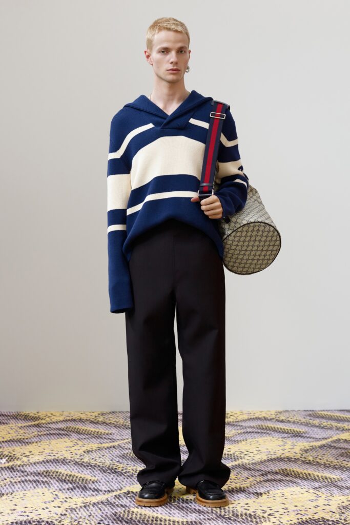 A relaxed blue striped hoodie paired with black pants for a casual yet stylish look.