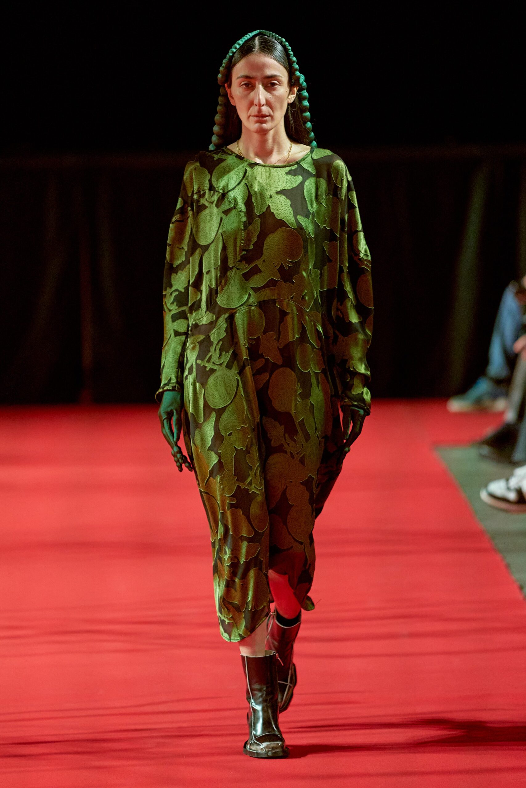 A relaxed green dress with long sleeves and a collared neckline featuring a printed design.