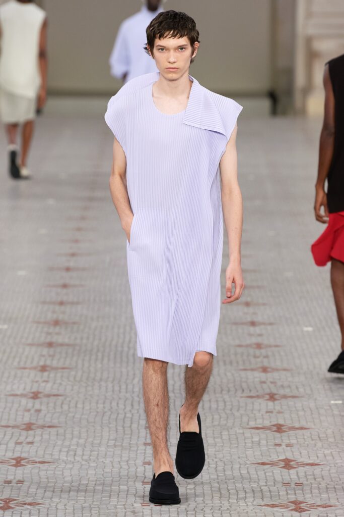 A relaxed lavender sleeveless dress with a high neckline and pleated design.