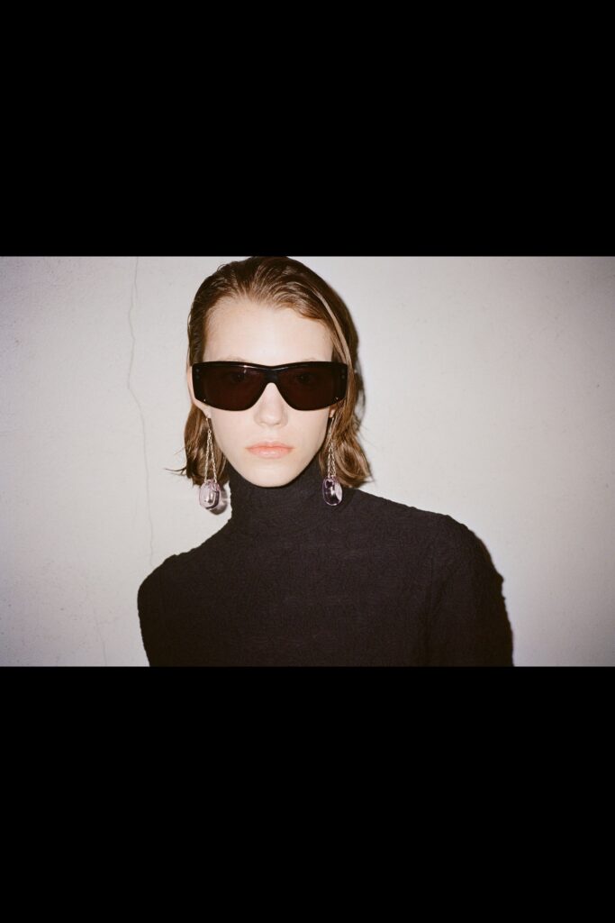 A fitted black wool top with a turtleneck and long sleeves, perfect for layering.