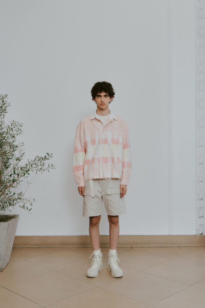 A relaxed pink striped jacket paired with beige shorts, perfect for a casual look.