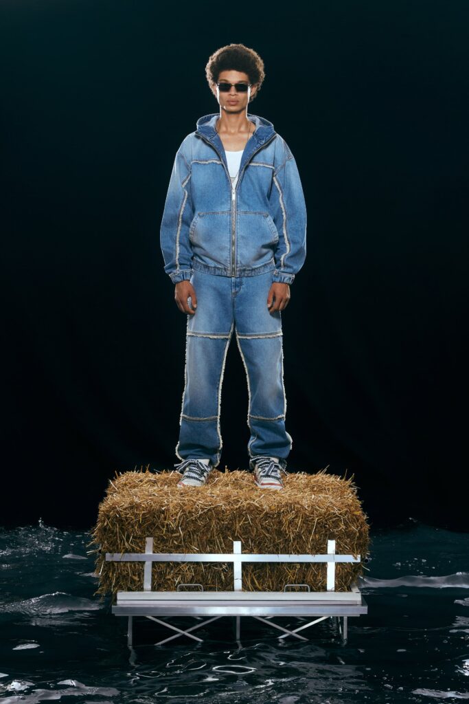 A relaxed blue denim jacket with long sleeves and straight-leg pants, featuring a zippered closure.